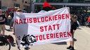 Menschen halten Plakat mit "Nazis blockieren statt tolerieren"